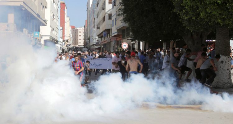 Police fire tear gas towards protesters during a demonstration against official abuses and corruption in the town of Al-Hoceima